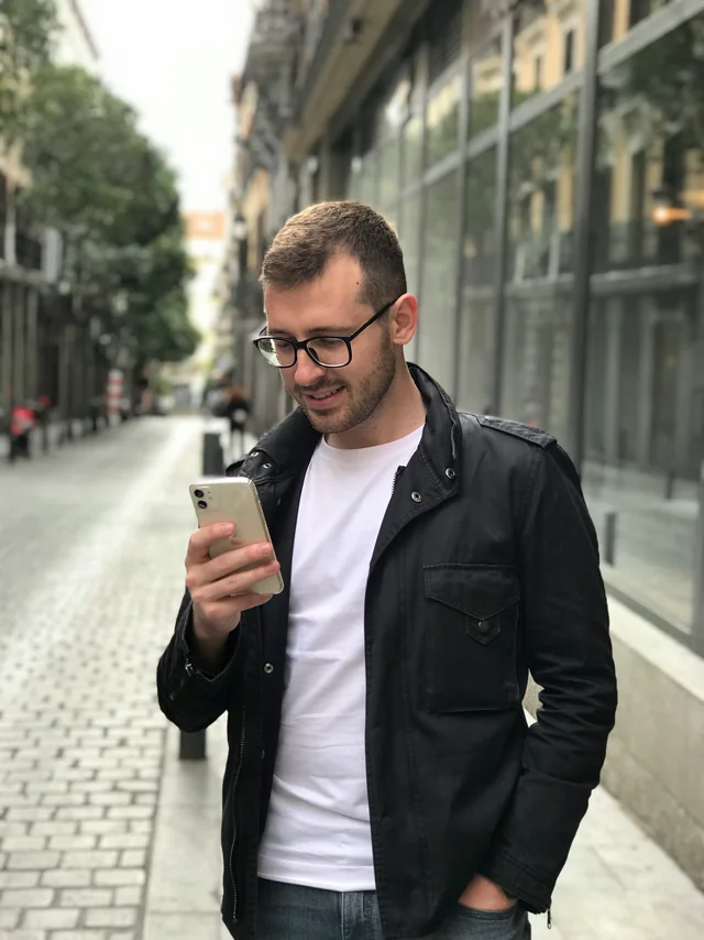 Someone looking something up on a phone in the street